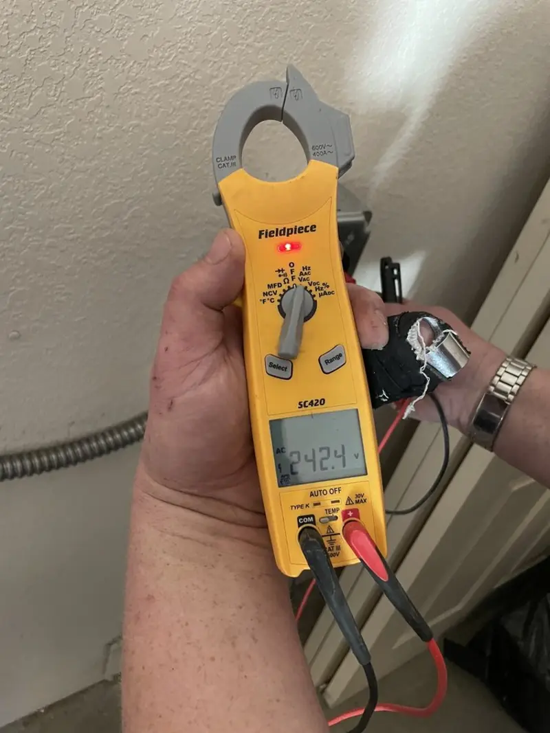 Voltage testing with clamp meter during Outlet Installation in Quincy